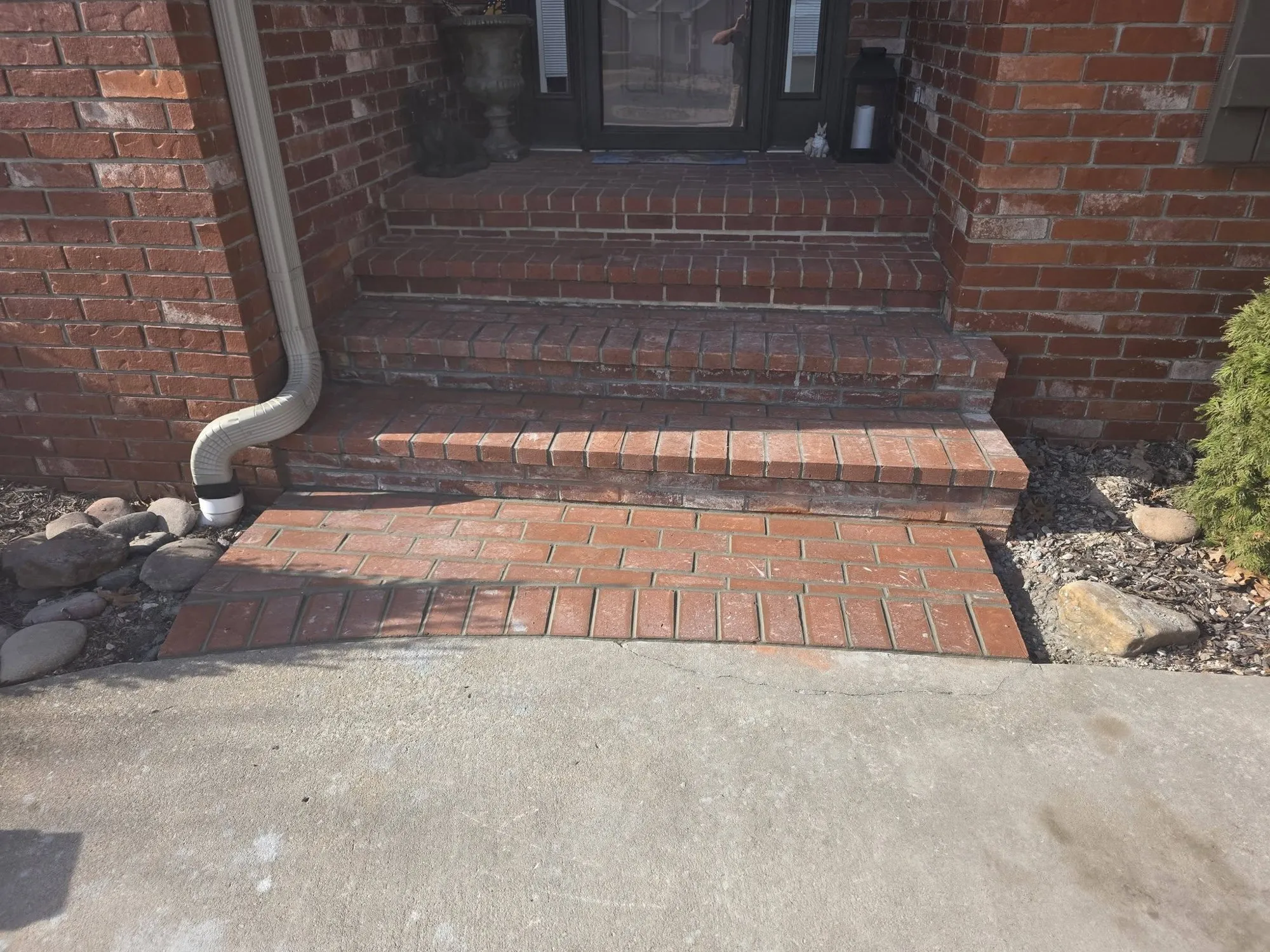 Rebuilt red brick front steps with a new brick landing at the sidewalk